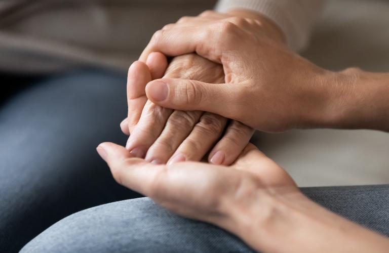woman holding another woman's hand