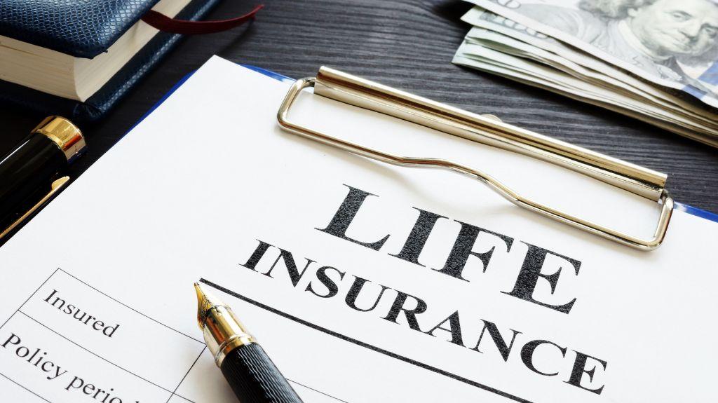 Life Insurance Form and Pen on a Clipboard