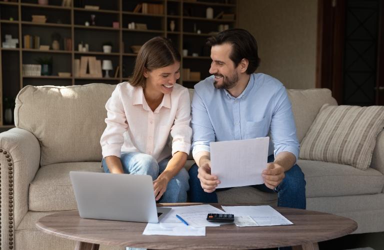 Happy couple doing domestic paperwork
