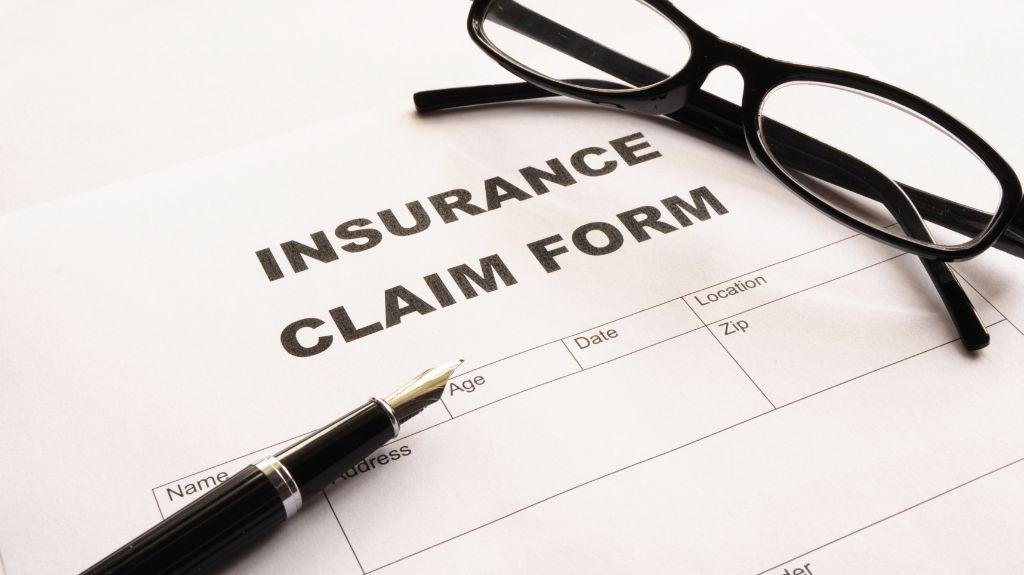 Insurance Claim Form with a Pen and Glasses