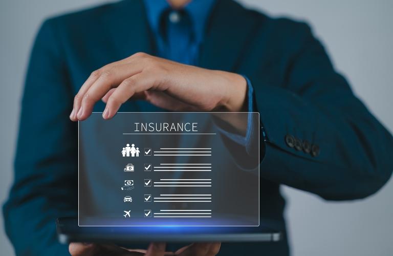 man holding laptop and showing meaning of insurance