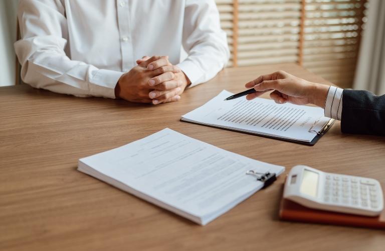 businessman signing contract with lawyer