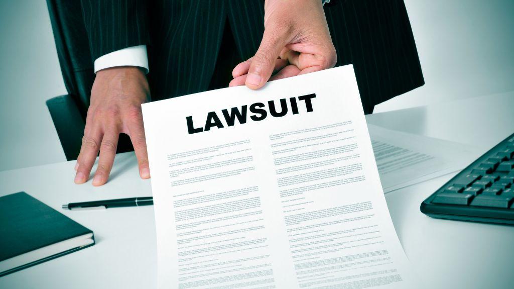 Lawyer Holding Document with Lawsuit at the Top