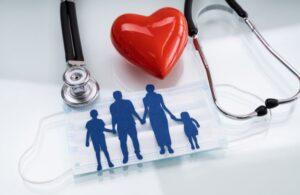 Family Cutout on Table with Red Heart, Stethoscope and Medical Mask