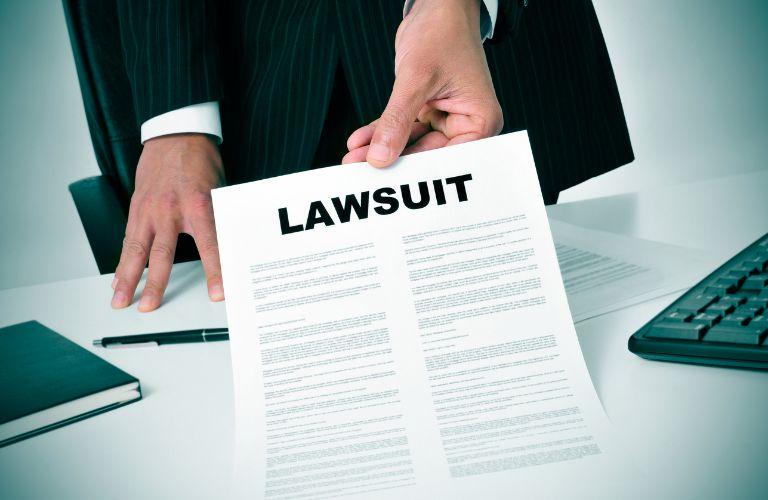 Lawyer Handing Over Lawsuit Documents