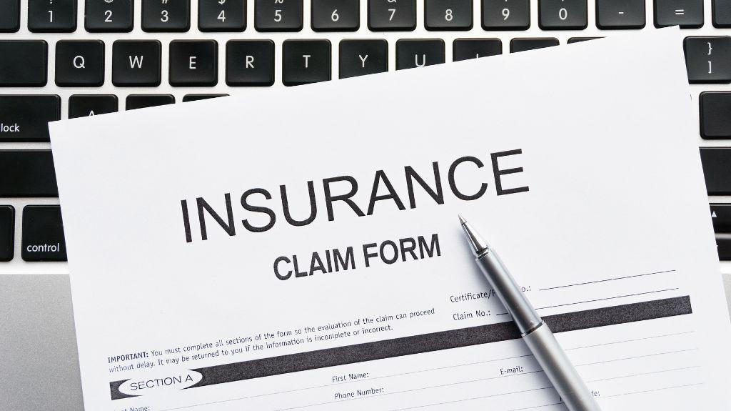 Insurance Claim Form with Keyboard in the Background