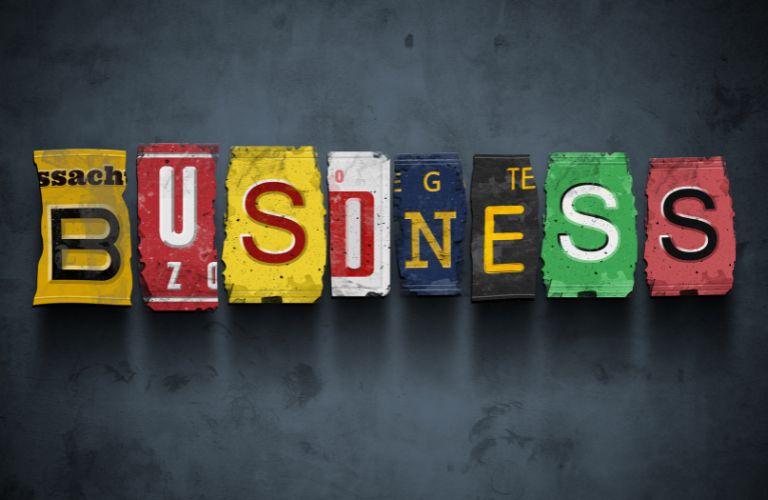 Business Spelled Out with Different Parts of License Plates on Black Background