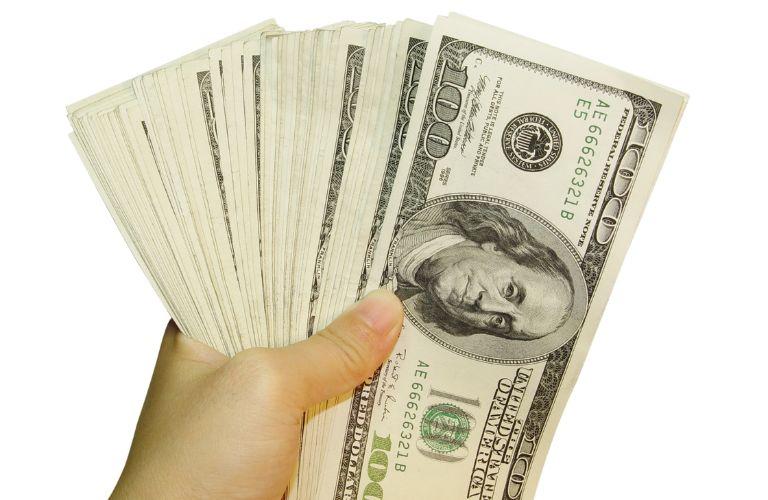 Hand Holding a Stack of $100 Bills
