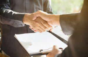 Business People Shaking Hands Over a Contract