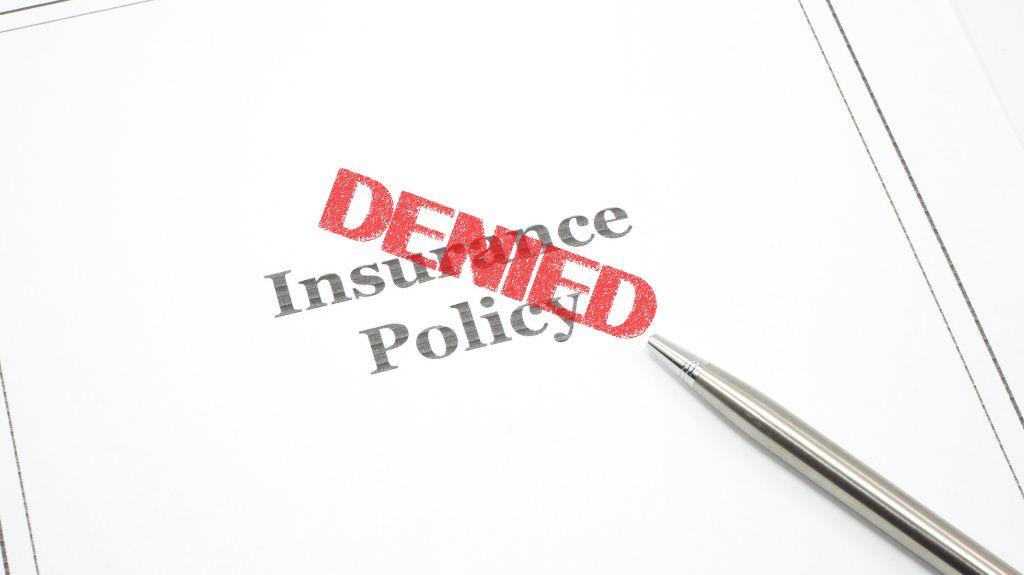 Insurance Policy Documents with Red Denied Stamp