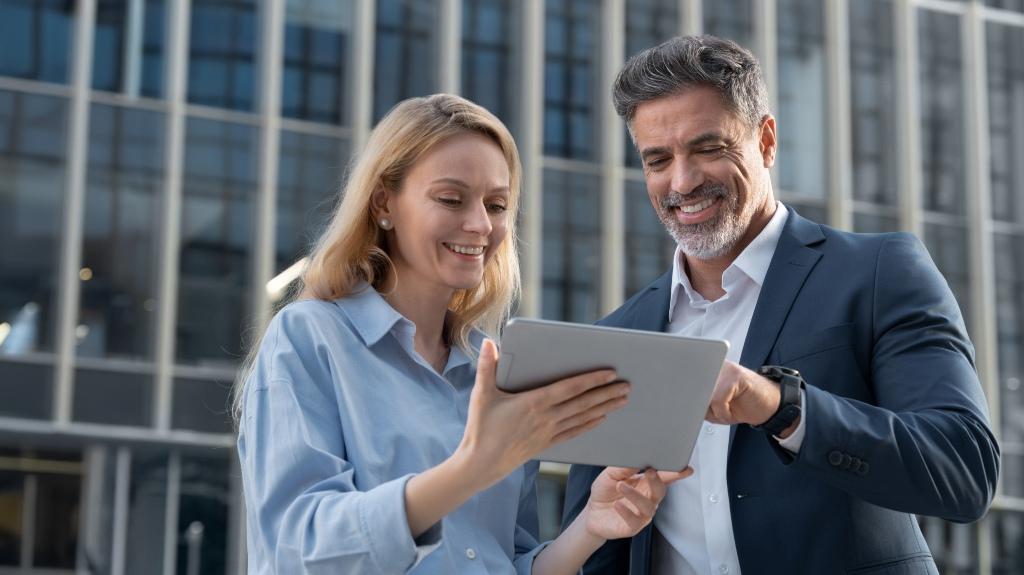 happy man and woman looking through insurance documents